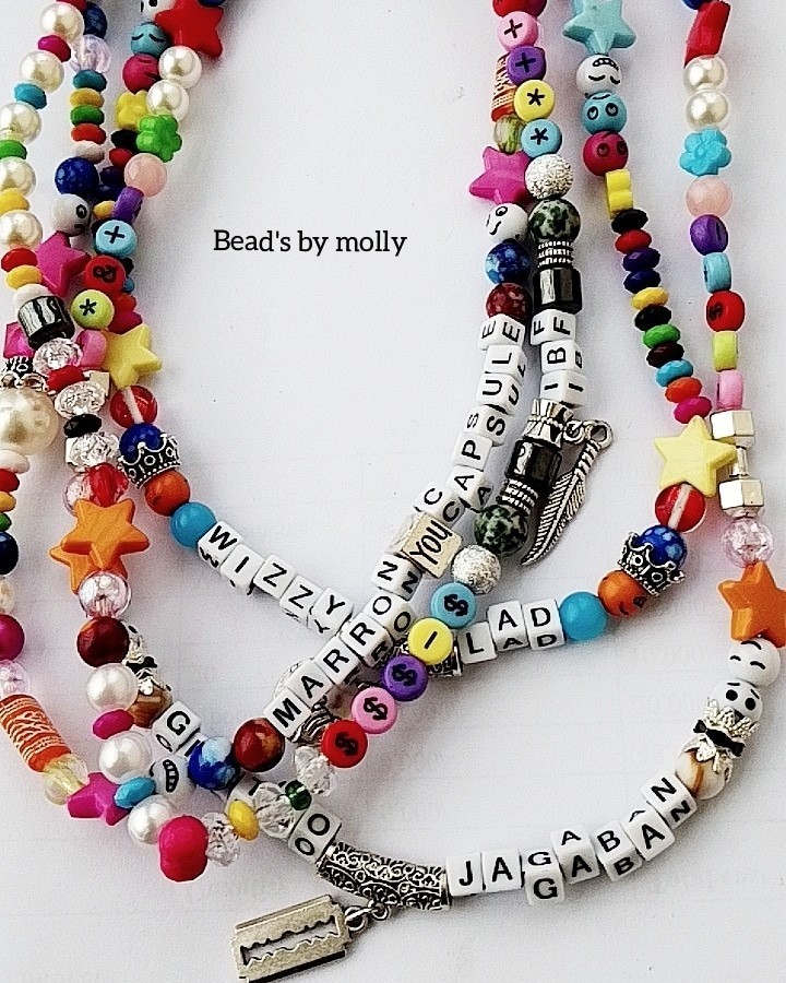 Multicolored pearl and plastic beaded necklaces with metal charms.